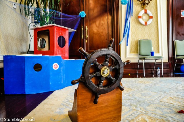 We made the boat and bought the steering wheel at an antique shop. Daddy set it on wood. 