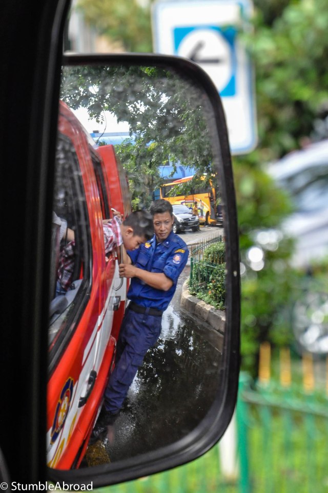 Fireman hanging from outside the truck 