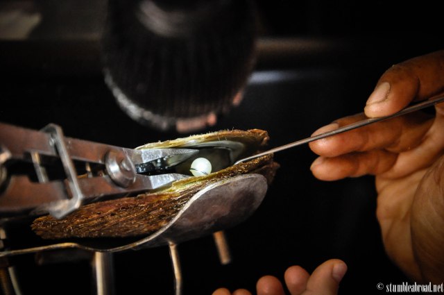 Taking the pearl out. 